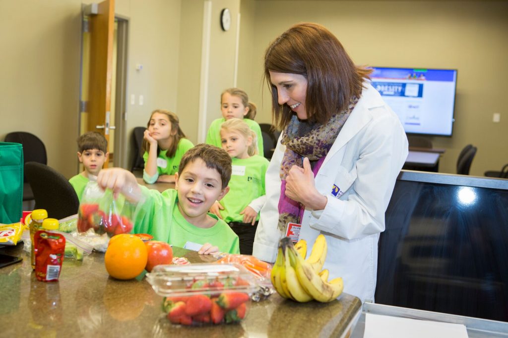 Kate Blumberg, a dietitian in Pennington’s Dietary Assessment and Nutrition Counseling department, instructs children during “Our Lifestyles, Our Lives”— a program that the center produces with Our Lady of the Lake Hospital. It teaches parents and children how to make healthy choices when planning and preparing meals and even includes field trips to the grocery store for real-world coaching 